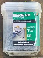 Front view of clear tub showing Rock-On branding, screw size 1-1/4", quantity 600, and intended use for Durock or Wonderboard