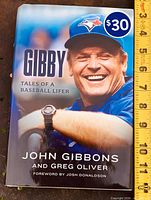 Front cover of hardcover book showing title, authors, price, and image of John Gibbons