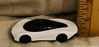 Left side of white McLaren Speedtail diecast against ruler