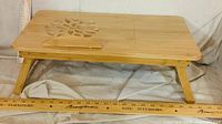 Lap desk unfolded showing full top, decorative cut-out, wrist rest, legs extended