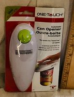 Front view of sealed One-Touch automatic can opener package
