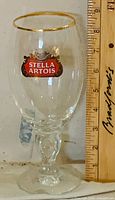 Front view of Stella Artois chalice beside ruler