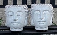Front view of both Buddha head planters