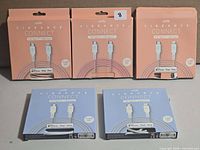 Five boxed Logiix Vibrance Connect cables, three peach and two blue
