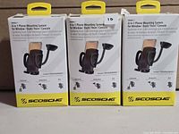 Front view of three boxed Scosche 4-in-1 phone mounts