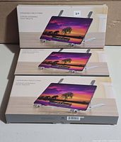 Three retail boxes labelled Expandable Tablet Stand
