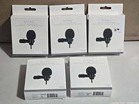 Front view of five Vital clip-on computer mic boxes