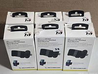 Front view of six boxed Scosche phone mount kits