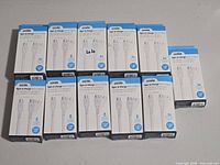 11 boxed Logiix cables arrayed on table