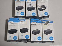 Front view of seven boxed chargers showing product and quantity
