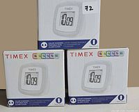 Front view of three Timex alarm clock boxes
