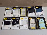 Group shot of ten boxed OtterBox phone cases
