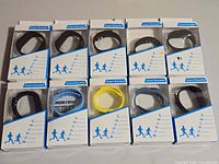 All ten boxed Smart Bracelets arranged in two rows, showing band colors