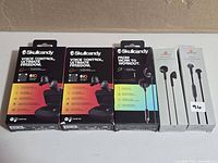 Five retail boxes of earbuds lined up