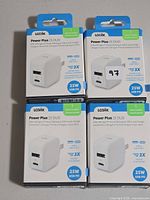 Four boxed Logiix Power Plus 25 DUO chargers front view