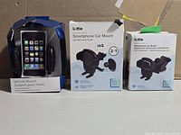 Three boxed phone mounts: two iOttie, one generic