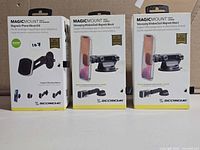 Front view of three boxed Scosche MagicMount Pro Extendo mounts