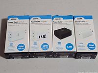 Front view of four boxed Logiix Power Cube chargers