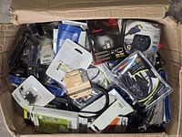 Top view of open box showing mix of packaged cables and accessories, Inland printer cable and HDMI spool visible