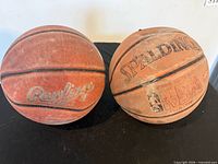 Spalding and Rawlings basketballs side by side showing brand logos