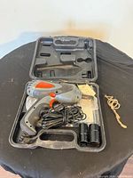 Impact wrench in molded carrying case with sockets visible