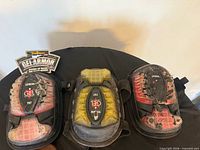 Front view of three worn Task Tools Gel Armor knee pads