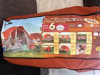 Packaged camping tent showing size and sleep capacity on label
