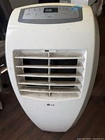 Front view of LG portable air conditioner showing vents and control panel