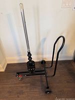 Full view of Motomaster tire caddy showing frame, wheels, vertical pole and handle