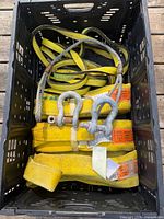 Crate containing yellow straps, wire sling and shackles