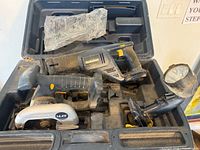 Overview of tools in case: reciprocating saw, circular saw, flashlight, case interior