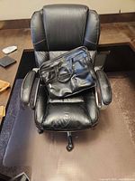 Office chair with Bugatti laptop bag placed on seat