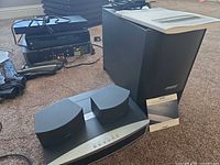 Full system view showing console, subwoofer, speakers and manual