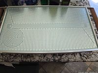 Top view of rectangular stainless steel warming tray with patterned glass heating surface