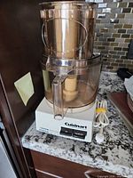 Front view showing Cuisinart base, control buttons, work bowl and lid