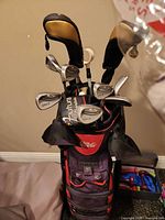Golf bag filled with clubs, front view