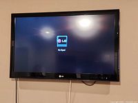 Front view of LG TV powered on showing no signal screen