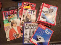 Group shot showing stacks of TIME, People, Sports Illustrated and Calgary magazines