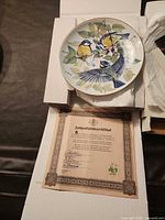 WWF bird decorative plate resting in box with authenticity certificate