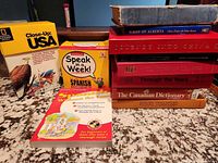 Overall lot showing books and boxed sets on countertop