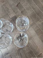 Cluster of clear stemless wine glasses, two with gold rims