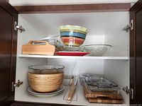 Cabinet view showing majority of lot items on two shelves