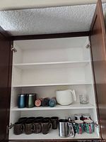 Cabinet view showing entire lot across two shelves