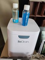 SoClean CPAP cleaner with two solution bottles visible on top