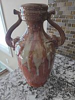 Front view of multicolor glazed stoneware vase with double handles