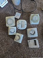 Group view of six white indoor timers, one white rear view, instruction leaflet