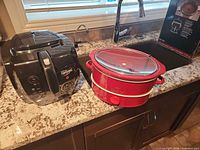 Rival slow cooker and Presto deep fryer on countertop