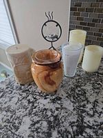 Group view of vase, candles and metal stand