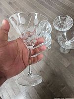 Holding coupe glass showing frosted dot and etched line pattern