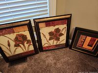 Front view of three framed art pieces
